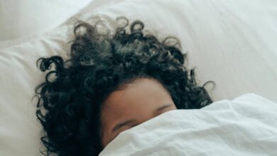 A kid is sleeping peacefully in her favourite white bedding & duvet cover in cold seasons of UK